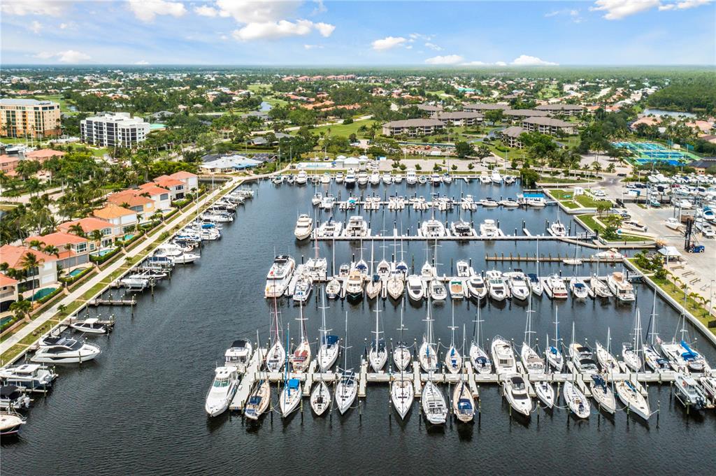 An aerial view of a marina filled with numerous boats docked in a residential area — 2070 KING TARPON DRIVE, PUNTA GORDA, FL