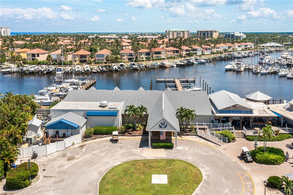 An aerial view shows a waterfront building with a circular driveway and boat slips — 2070 KING TARPON DRIVE, PUNTA GORDA, FL