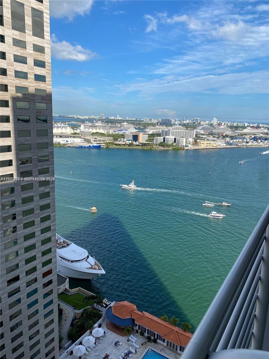 An elevated view of a harbor with boats, a cruise terminal, and a high-rise building — 335 S Biscayne Blvd # 2900, Miami FL 33131, MIAMI, FL