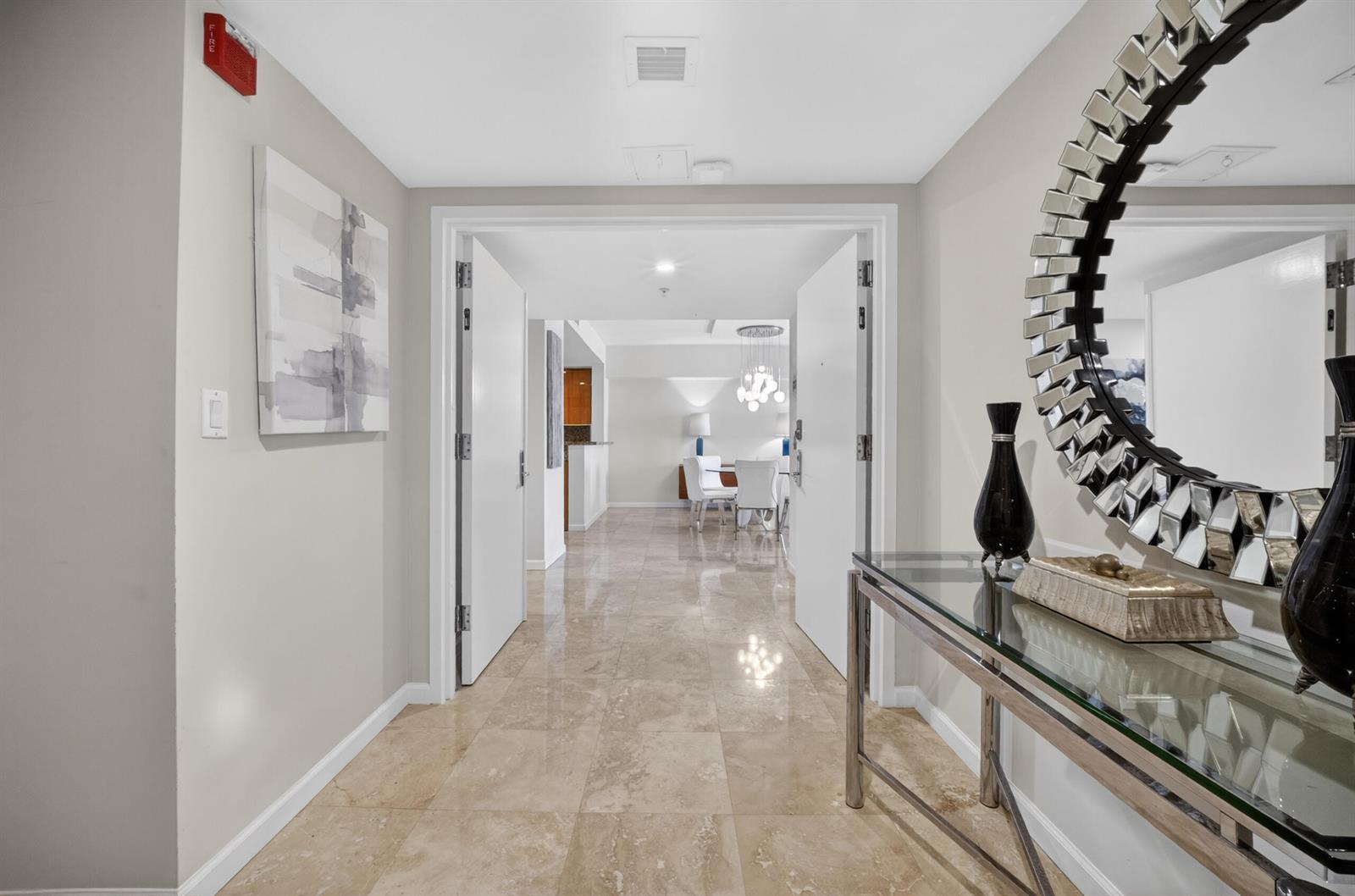 A tiled entryway leads through double doors into a dining area with a glass console table — 45 Hendricks Isle # 403, Fort Lauderdale FL 33301, FORT LAUDERDALE, FL