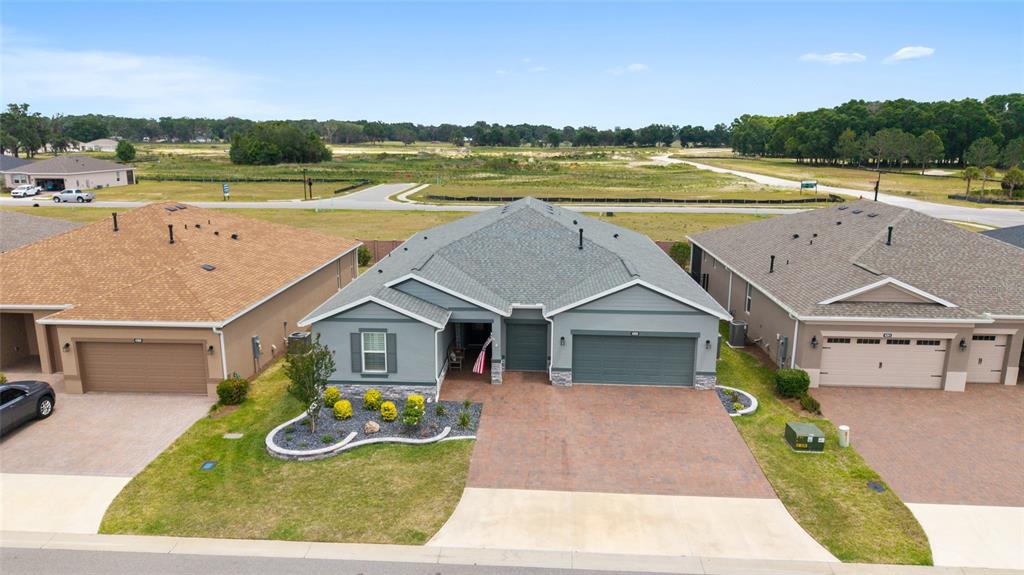 An aerial view shows a single-story house with a gray exterior and a paved driveway — 4355 NW 53RD COURT, OCALA, FL