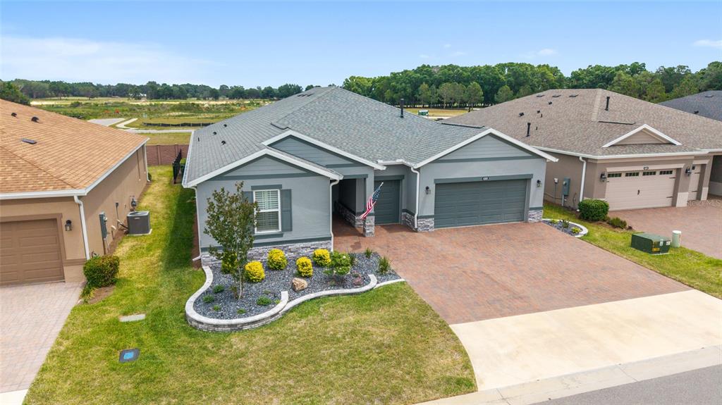 An aerial view shows a gray single-story house with a paved driveway and landscaped yard — 4355 NW 53RD COURT, OCALA, FL
