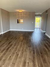 An empty room features wood-look flooring, gray walls, a ceiling light, and a balcony door — 1025 SE 3rd Avenue # 303, Dania Beach FL 33004, DANIA BEACH, FL