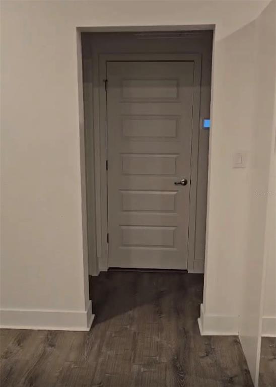 A doorway with a five-panel door leads into a room with gray wood-look flooring — 14978 LEBEAU LOOP, WINTER GARDEN, FL
