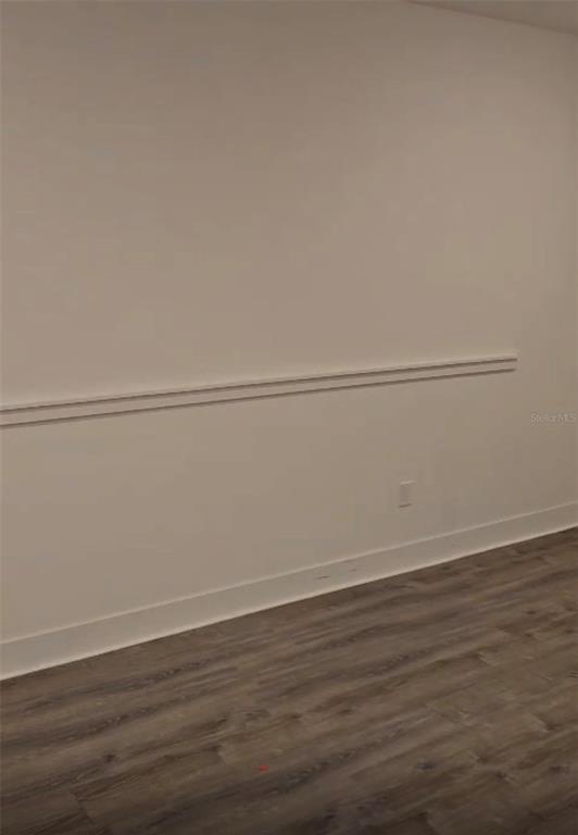 A room with light-colored walls, a chair rail, baseboards, and wood-look flooring — 14978 LEBEAU LOOP, WINTER GARDEN, FL