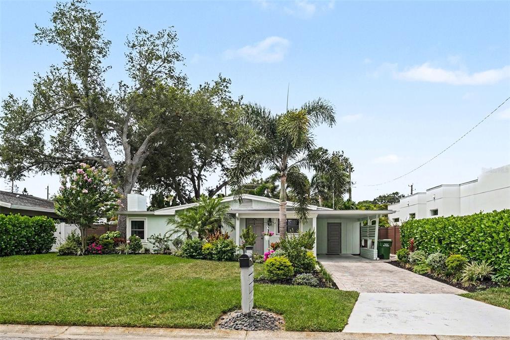 A single-story house with a paved driveway, palm tree, and large oak tree in front — 2344 TEMPLE STREET, SARASOTA, FL