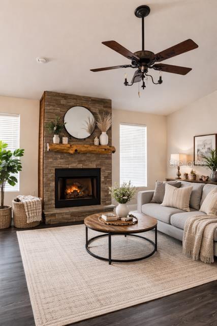 A living room features a stone fireplace, a round coffee table, and a ceiling fan — 9880 NW 110TH STREET, CHIEFLAND, FL