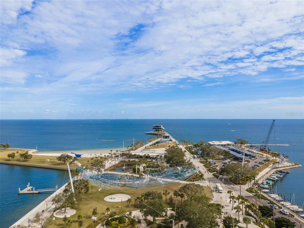 An aerial view shows a coastal park with a long pier extending into the water — 100 BEACH DRIVE NE UNIT 1501, ST PETERSBURG, FL