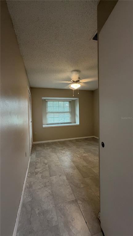 A bedroom with light-colored tile flooring, a ceiling fan, and a recessed window with blinds — 6434 ROCKINGTREE LANE, ORLANDO, FL