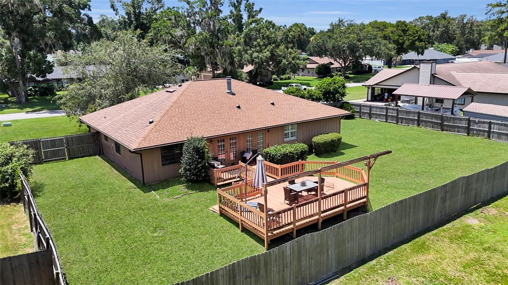 An aerial view shows a house with a brown roof and a wooden deck — 2045 SE 32ND STREET, OCALA, FL
