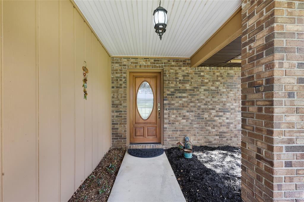 A front entryway features a wooden door with an oval window, brick walls, and siding — 2045 SE 32ND STREET, OCALA, FL