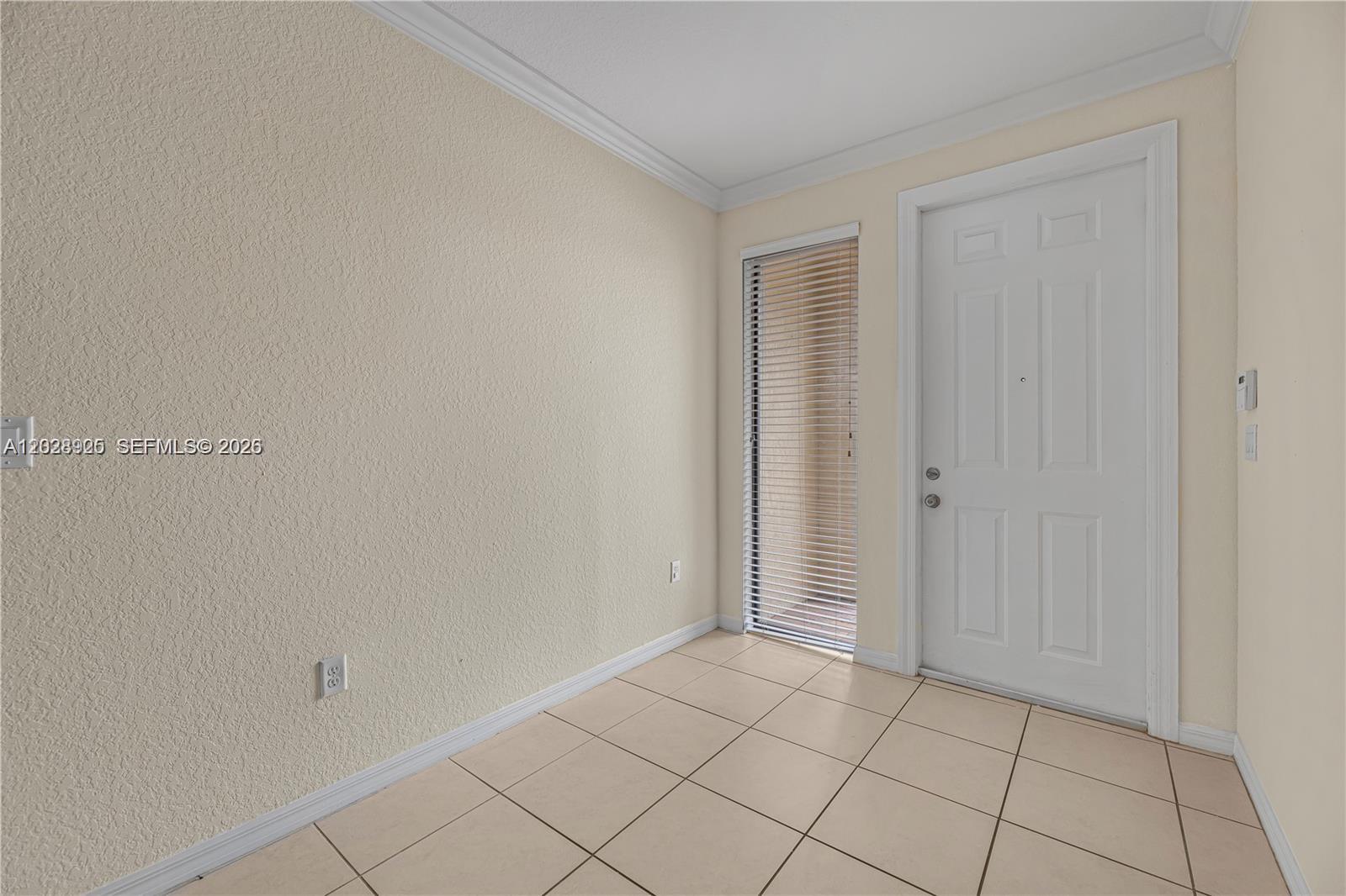 An entryway features beige tiled floors, a white door, and a vertical window with blinds — 3345 NW 11th Ave, Pompano Beach FL 33064, POMPANO BEACH, FL