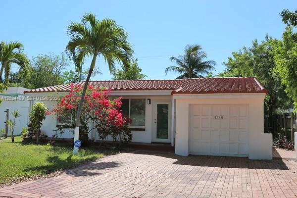 A single-story house with a red tile roof, white exterior, and a paved driveway — 1380 71st St, Miami Beach FL 33141, MIAMI BEACH, FL