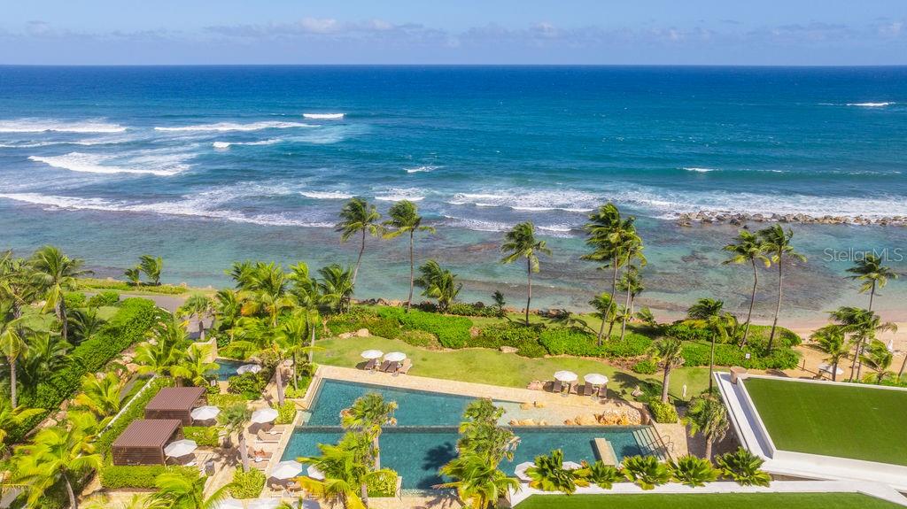 An aerial view of a swimming pool overlooking a beach and the ocean — 200 Dorado Beach Dr WEST BEACH PH UNIT 3141-3142, DORADO, PR