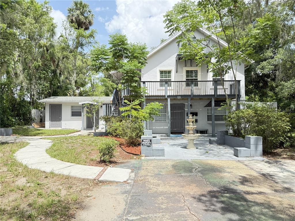 A two-story house with a balcony, a stone patio, and a fountain in the front yard — 123 S ARLINGTON AVENUE UNIT C, DELAND, FL