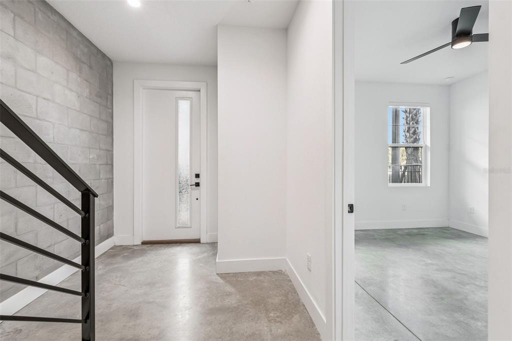 An entryway with a concrete floor, a block wall, and a doorway to a room — 2724 5TH AVENUE S, ST PETERSBURG, FL