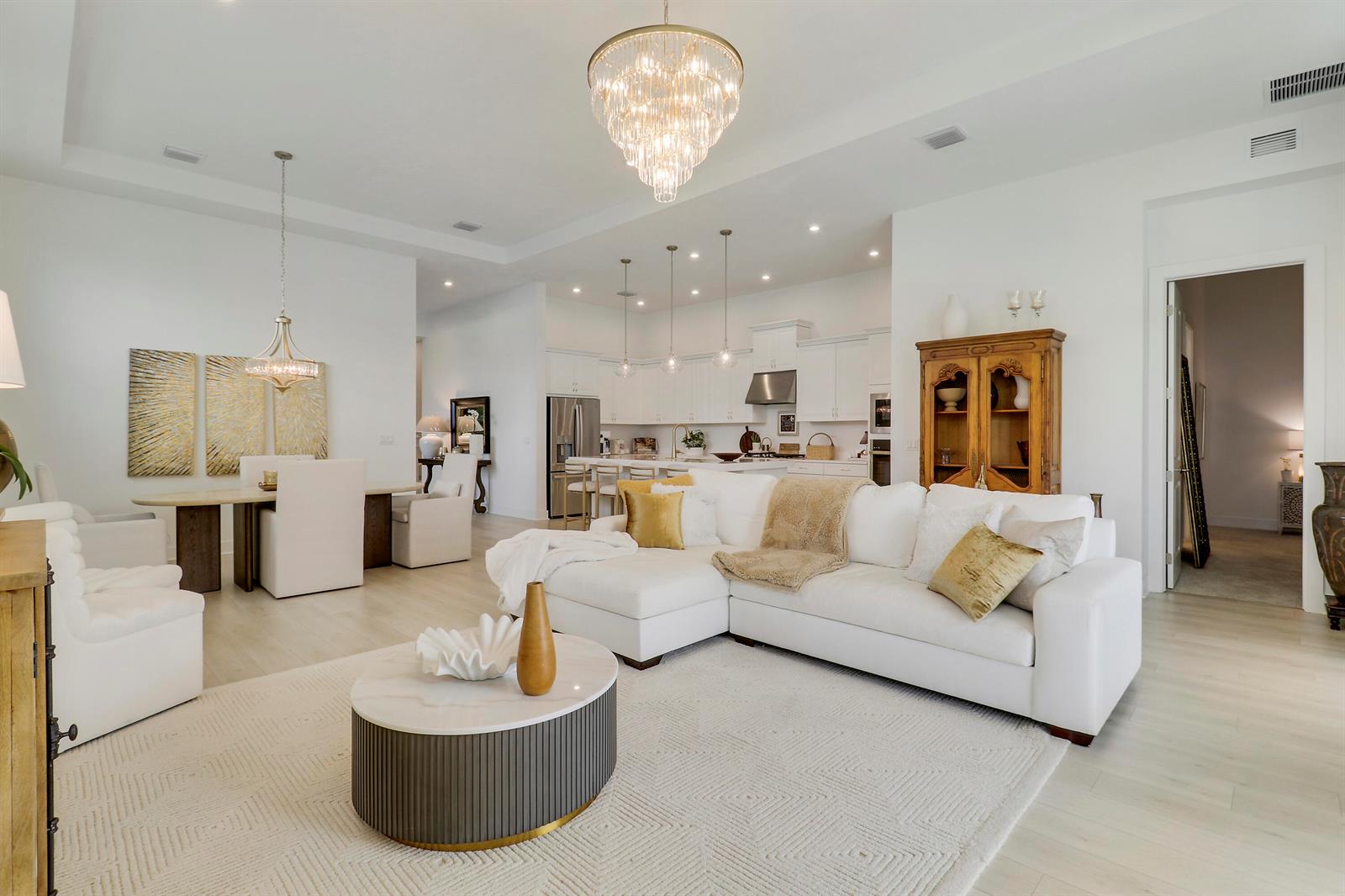 A modern single-story house with a two-car garage, gray tile roof, and landscaped front yard — 7030 SE Haven Lane, Stuart FL 34997, STUART, FL
