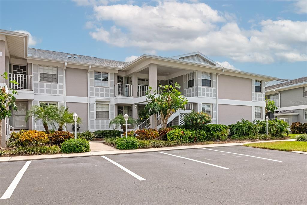 A two-story apartment building with a parking lot in the foreground — 1145 EDGEWATER CIRCLE UNIT 1145, BRADENTON, FL