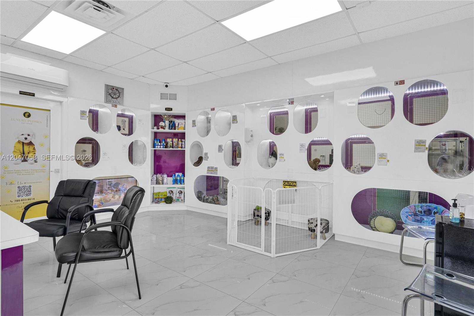 A pet store interior features white walls, tiled floors, and multiple glass-fronted animal enclosures — 8981 SW 40th St, Miami FL 33165, MIAMI, FL