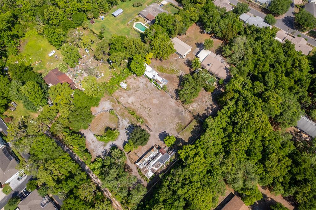 An aerial view shows a large, partially cleared residential lot with several structures and trees — 1281 NATURES WAY, WINTER SPRINGS, FL