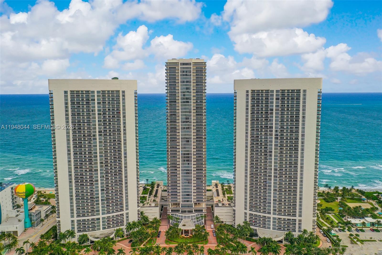 An aerial view of three tall residential towers situated on a beach along the ocean — 1800 S Ocean Dr # 3805, Hallandale Beach FL 33009, HALLANDALE BEACH, FL