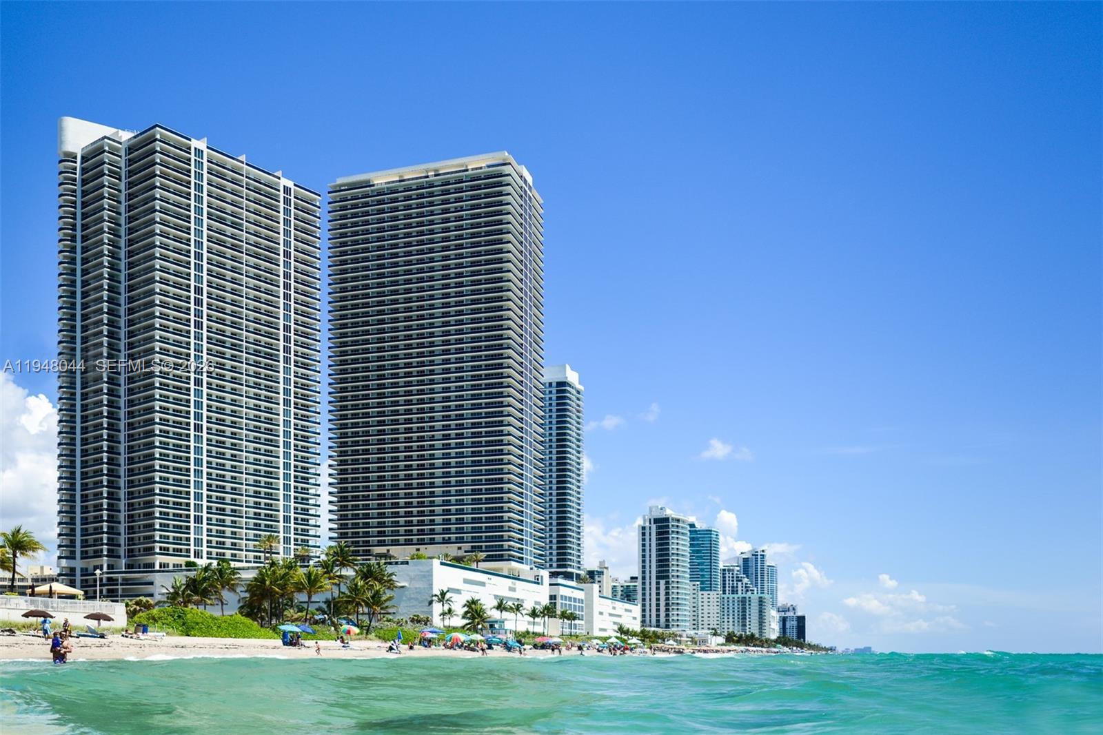 A beach view of several tall residential skyscrapers under a clear blue sky — 1800 S Ocean Dr # 3805, Hallandale Beach FL 33009, HALLANDALE BEACH, FL
