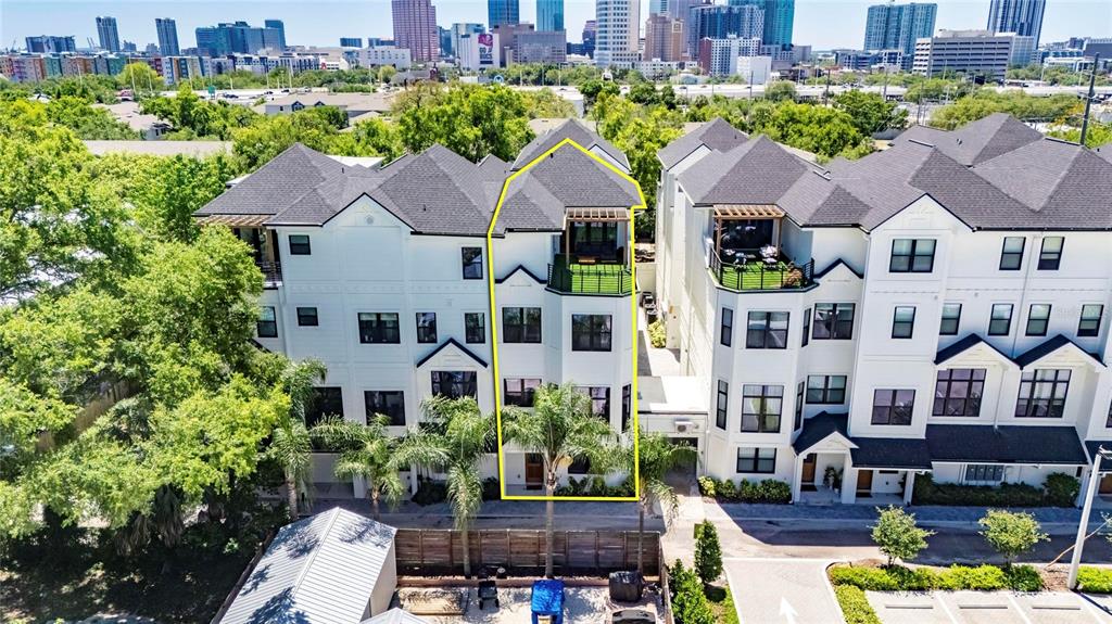 An aerial view shows a multi-story townhouse with a rooftop terrace and a small yard — 1801 N MORGAN STREET UNIT 11, TAMPA, FL