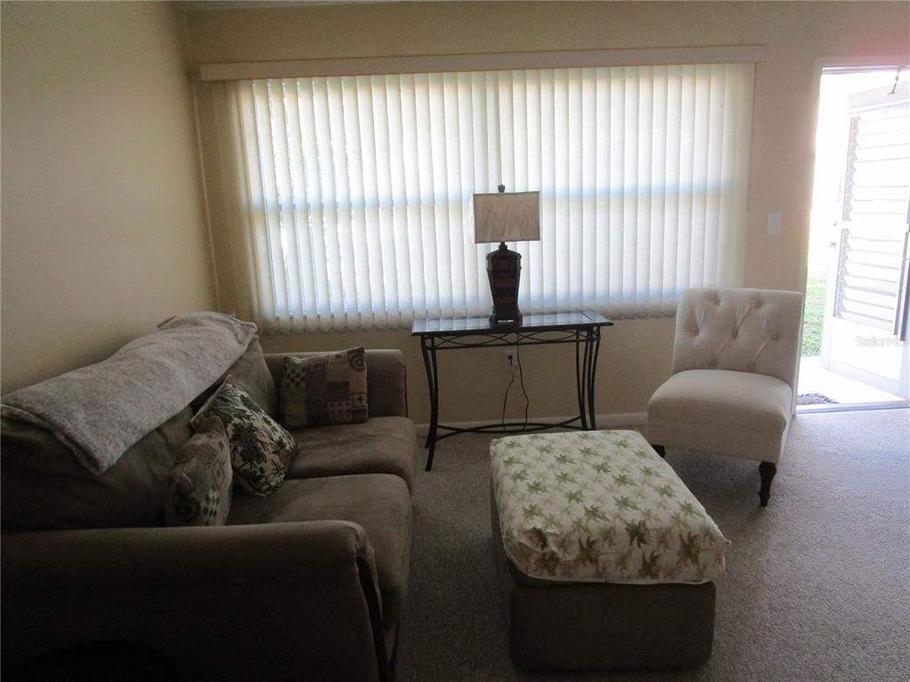 A living room features a sofa, an ottoman, an accent chair, and a console table — 5876 21ST STREET N UNIT 3, ST PETERSBURG, FL