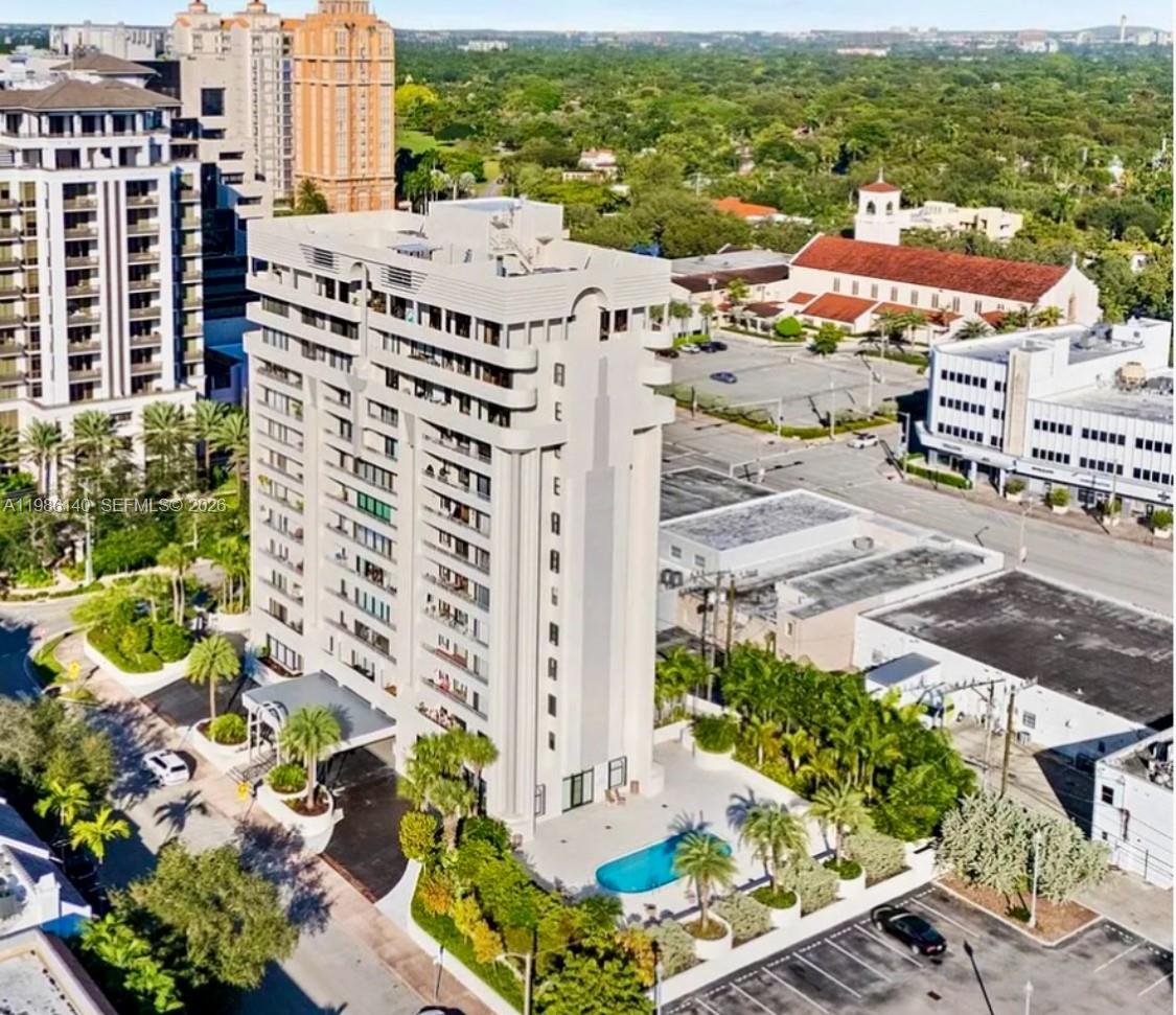 An aerial view of a high-rise apartment building with a pool and surrounding parking lots — 441 Valencia Ave # 803, Coral Gables FL 33134, CORAL GABLES, FL