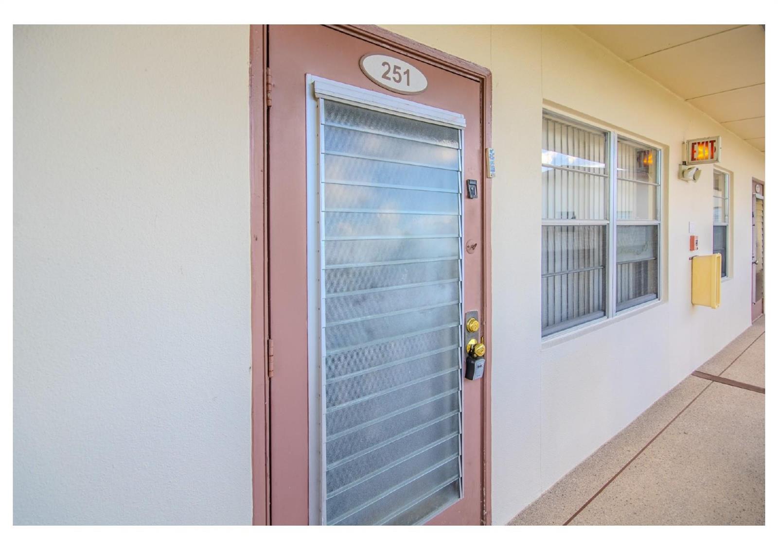 A brown door with a louvered glass insert and the number 251 on an exterior walkway — 251 Preston F # 251, Boca Raton FL 33434, BOCA RATON, FL