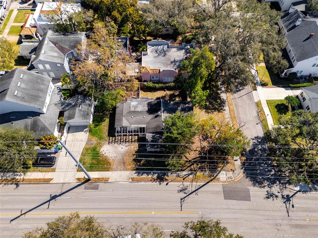 An aerial view shows a residential property with a house, driveway, and surrounding trees — 2627 W WATROUS AVENUE, TAMPA, FL