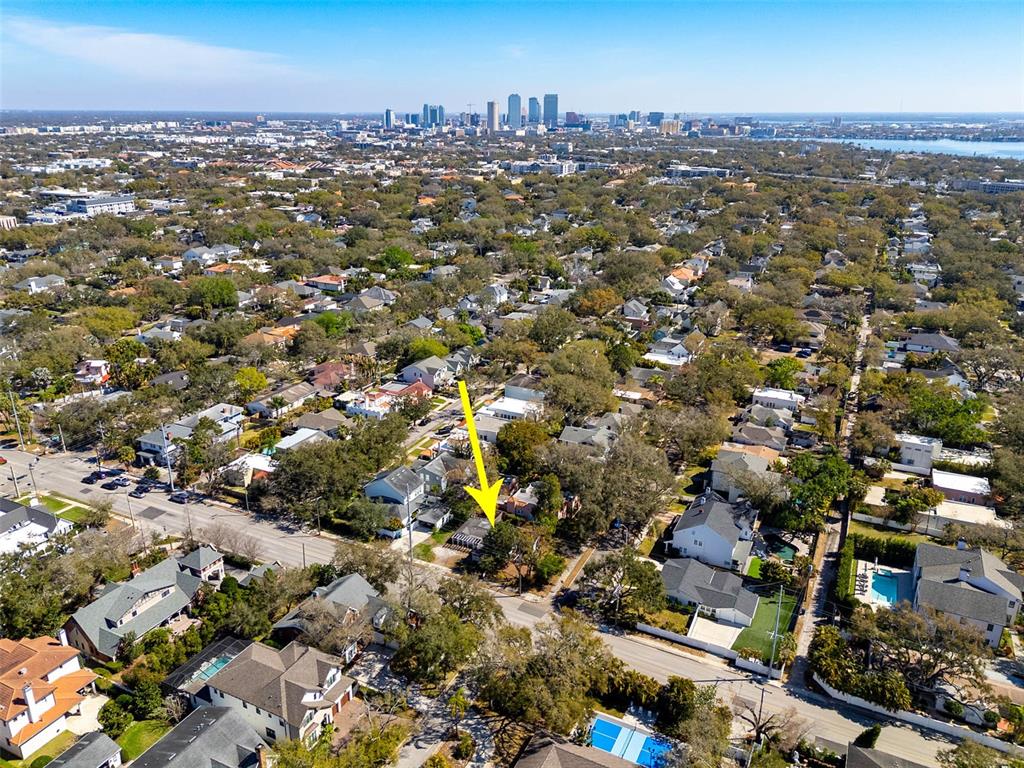 An aerial view shows a residential neighborhood with a yellow arrow pointing to a house — 2627 W WATROUS AVENUE, TAMPA, FL