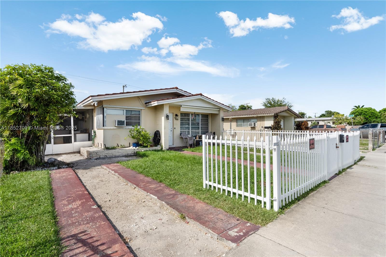 A single-story house with a white picket fence and a red-painted driveway — 9311 SW 37th St, Miami FL 33165, MIAMI, FL