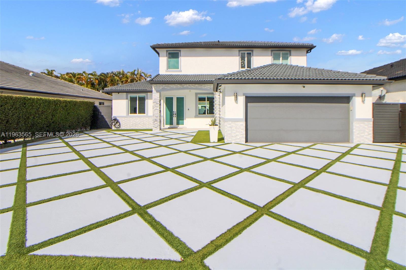 A two-story house features a large driveway with a diamond-patterned concrete and grass grid — 15967 SW 141st St, Miami FL 33196, MIAMI, FL