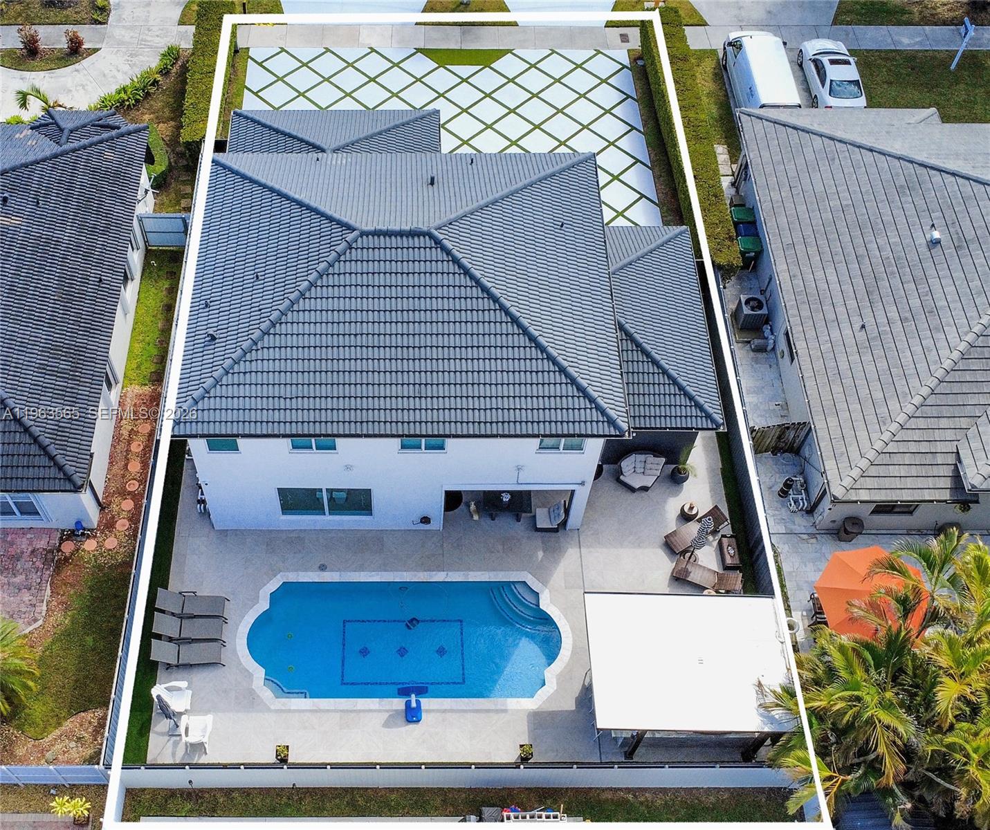 An aerial view shows a two-story house with a tiled roof, pool, and paved patio — 15967 SW 141st St, Miami FL 33196, MIAMI, FL