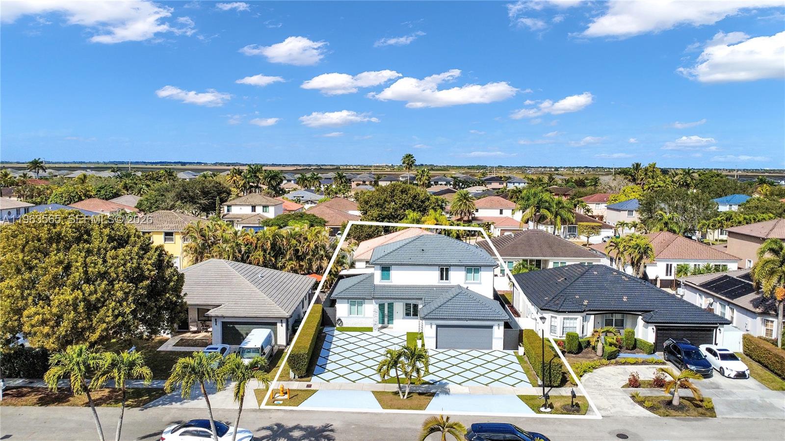 An aerial view shows a two-story house with a tiled roof and a patterned driveway — 15967 SW 141st St, Miami FL 33196, MIAMI, FL