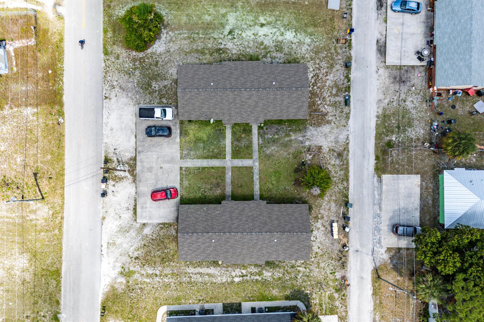 An aerial view shows a duplex building with a central courtyard and concrete parking pads — 1205 Ave K, Fort Pierce FL 34950, FORT PIERCE, FL