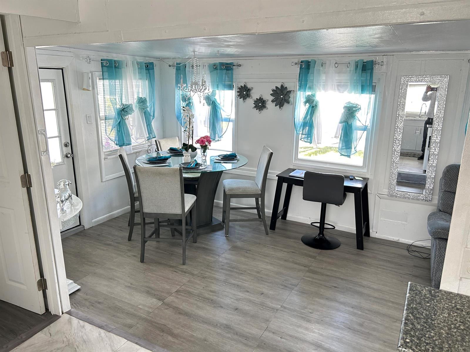 A dining area features a glass table, grey chairs, teal curtains, and wood-look flooring — 1325 S 33 Road, Hollywood FL 33021, HOLLYWOOD, FL