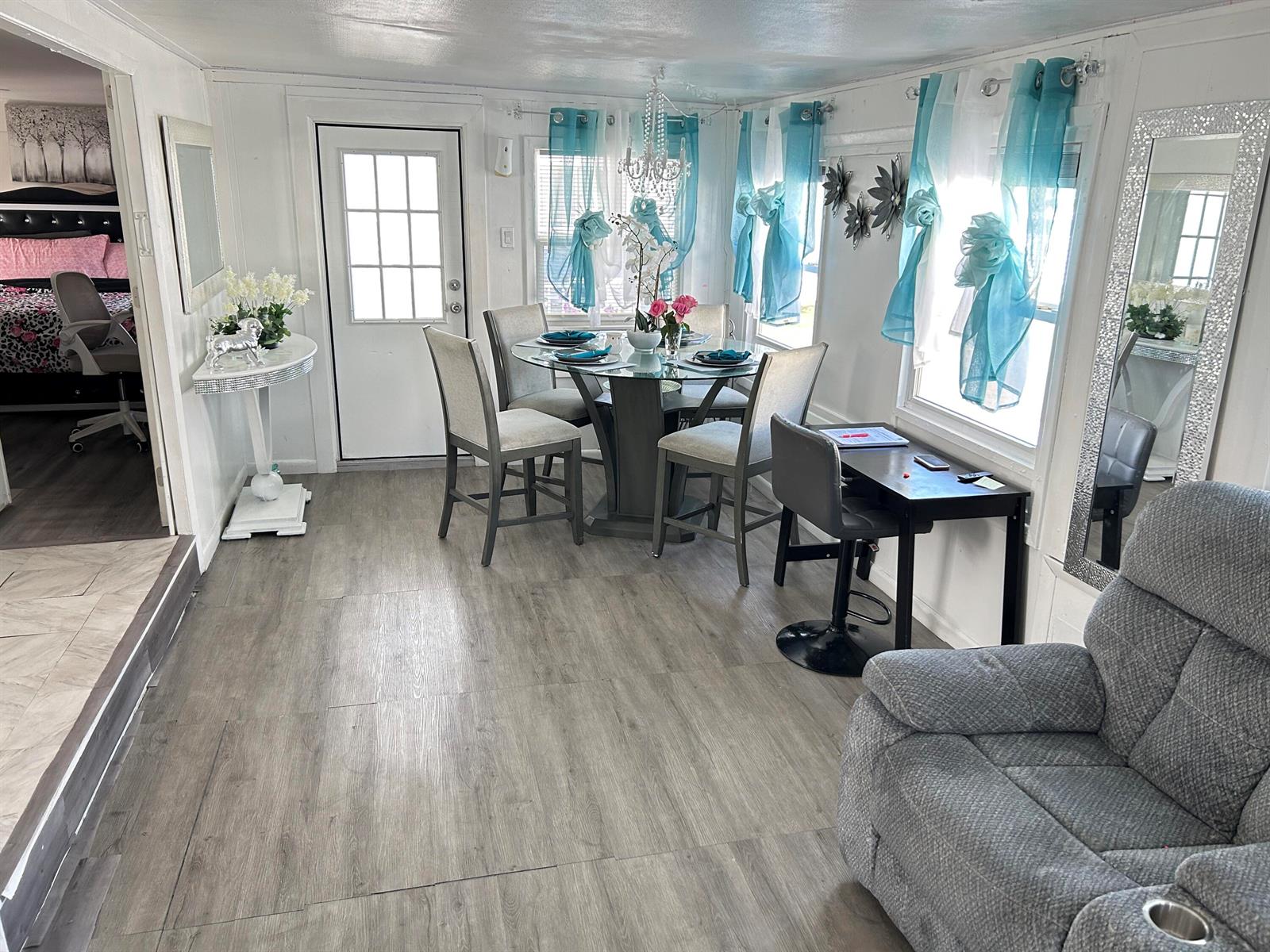 A dining area with a glass table, gray chairs, and light wood-look flooring — 1325 S 33 Road, Hollywood FL 33021, HOLLYWOOD, FL