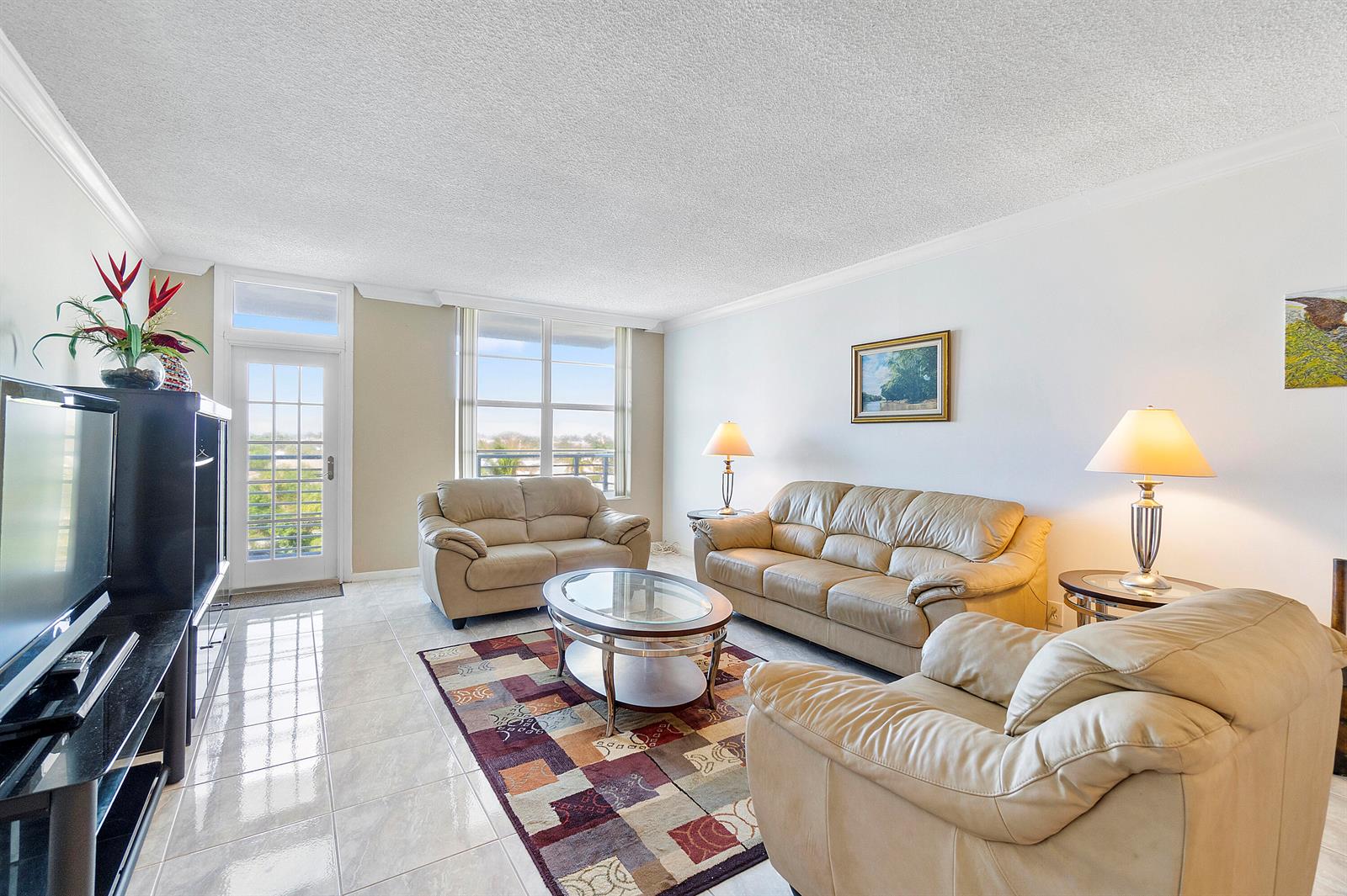 A living room features beige leather furniture, a glass coffee table, and a patterned rug — 2851 S Ocean Boulevard # B, Boca Raton FL 33432, BOCA RATON, FL