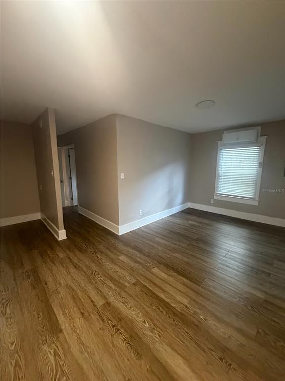 An empty room with light wood-look flooring, beige walls, and a window with blinds — 819 6TH STREET N UNIT 2, ST PETERSBURG, FL