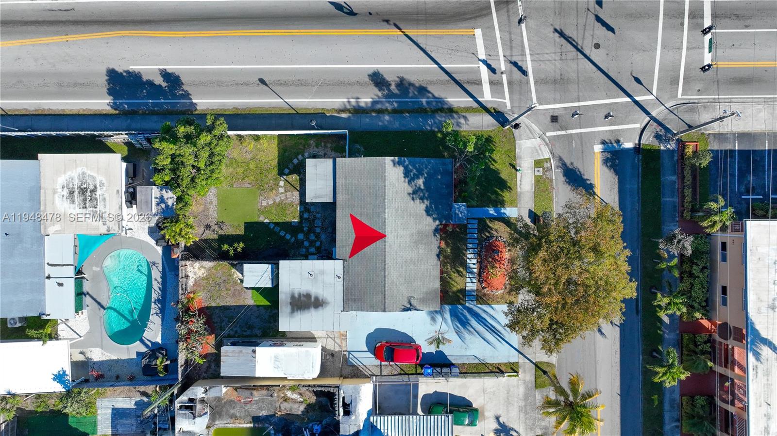 An aerial view shows a house with a red arrow on the roof and a pool — 822 N 20th Ave, Hollywood FL 33020, HOLLYWOOD, FL