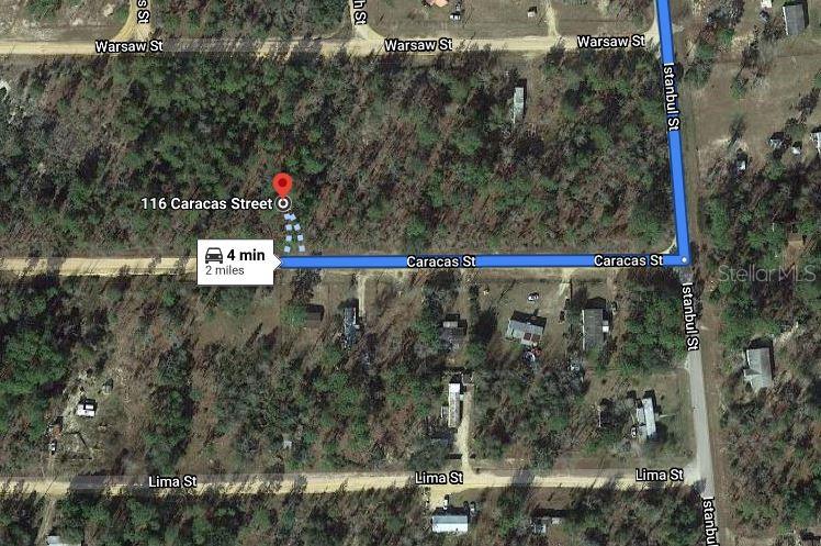 This is a satellite map view showing a wooded lot and surrounding streets — 116 CARACAS STREET, INTERLACHEN, FL