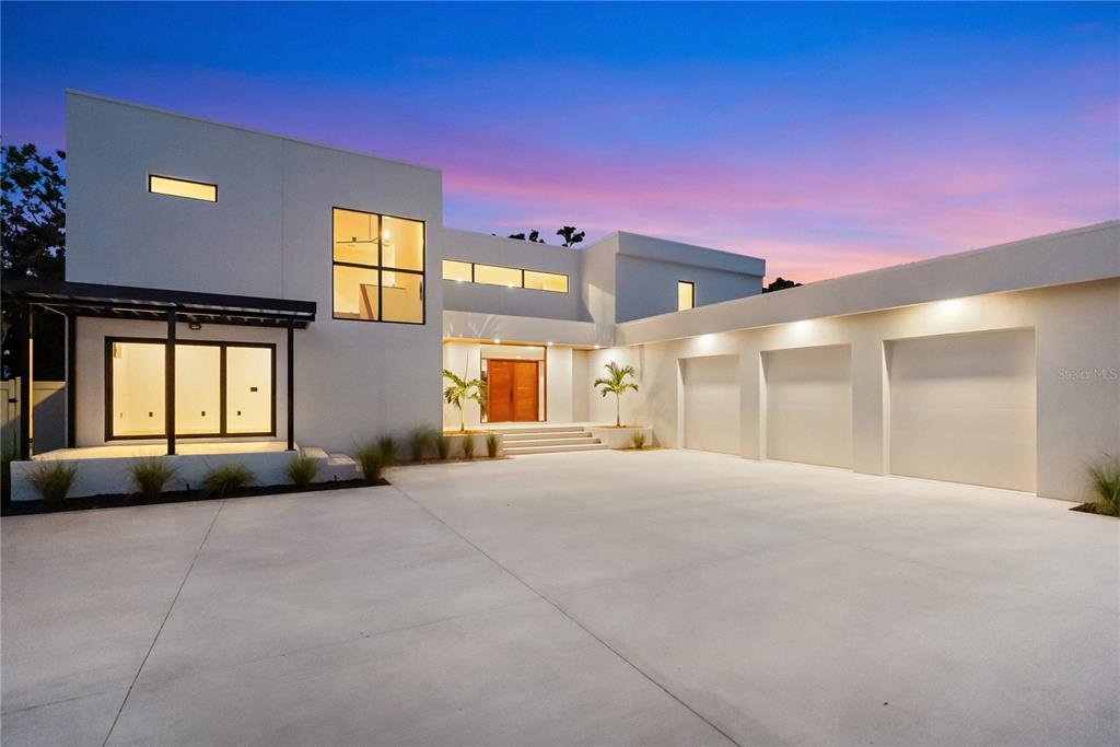 A modern two-story house with a three-car garage and a large concrete driveway — 1759 WALDEMERE STREET, SARASOTA, FL