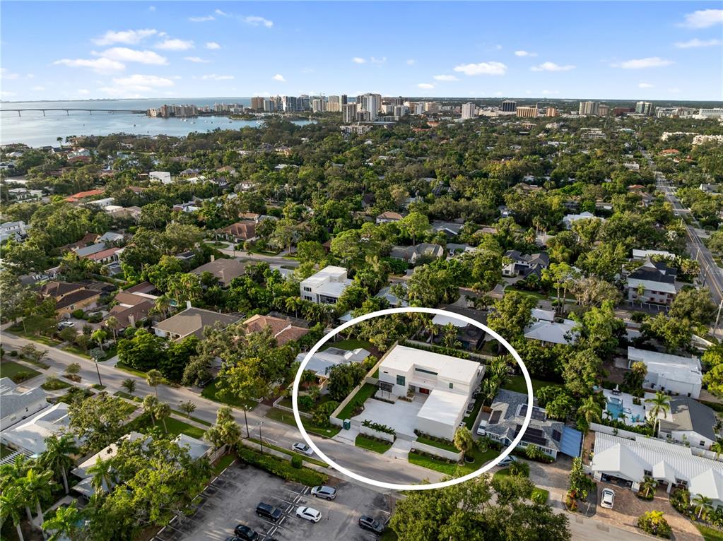 An aerial view shows a modern white house with a flat roof and a courtyard — 1759 WALDEMERE STREET, SARASOTA, FL