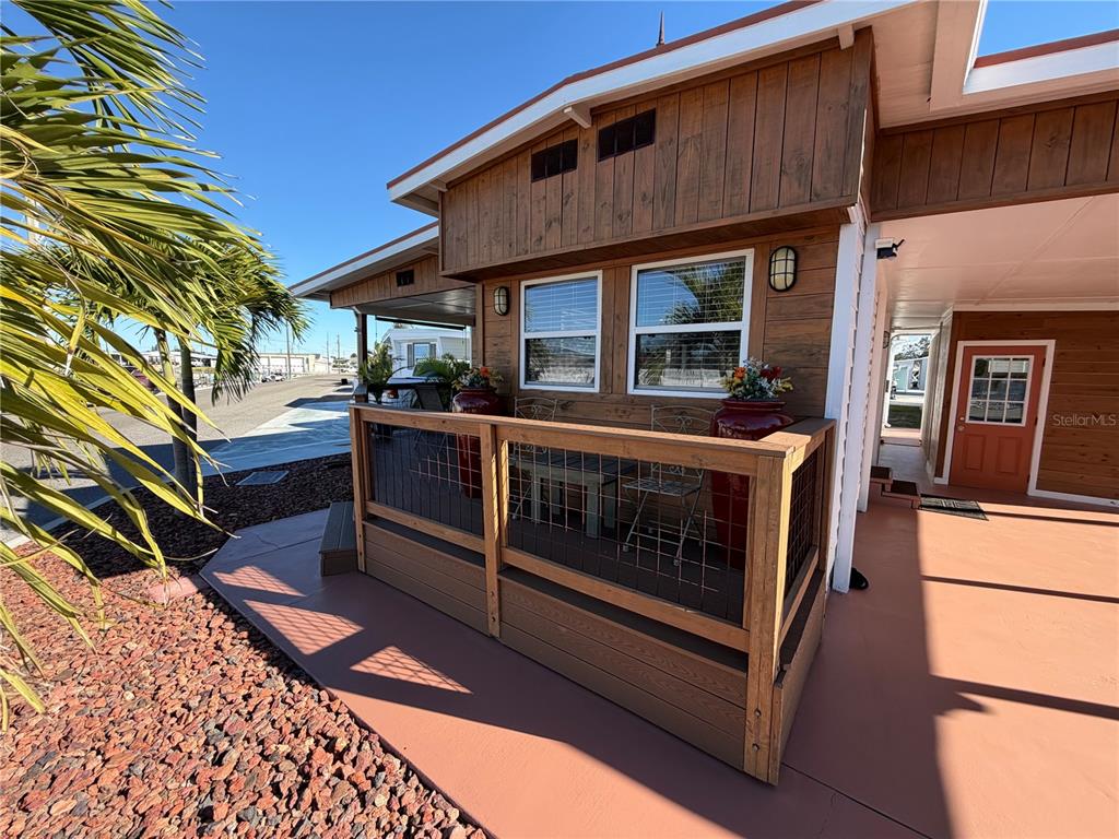 A wooden deck with a wire railing sits in front of a house exterior — 2216 PENNSYLVANIA AVENUE, BRADENTON, FL