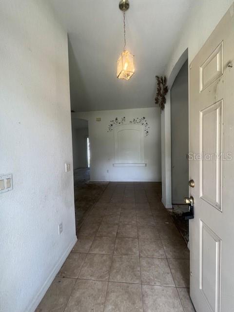 An entryway with tiled flooring leads to a living area featuring a decorative wall niche — 5566 LAVENDER AVENUE, NORTH PORT, FL