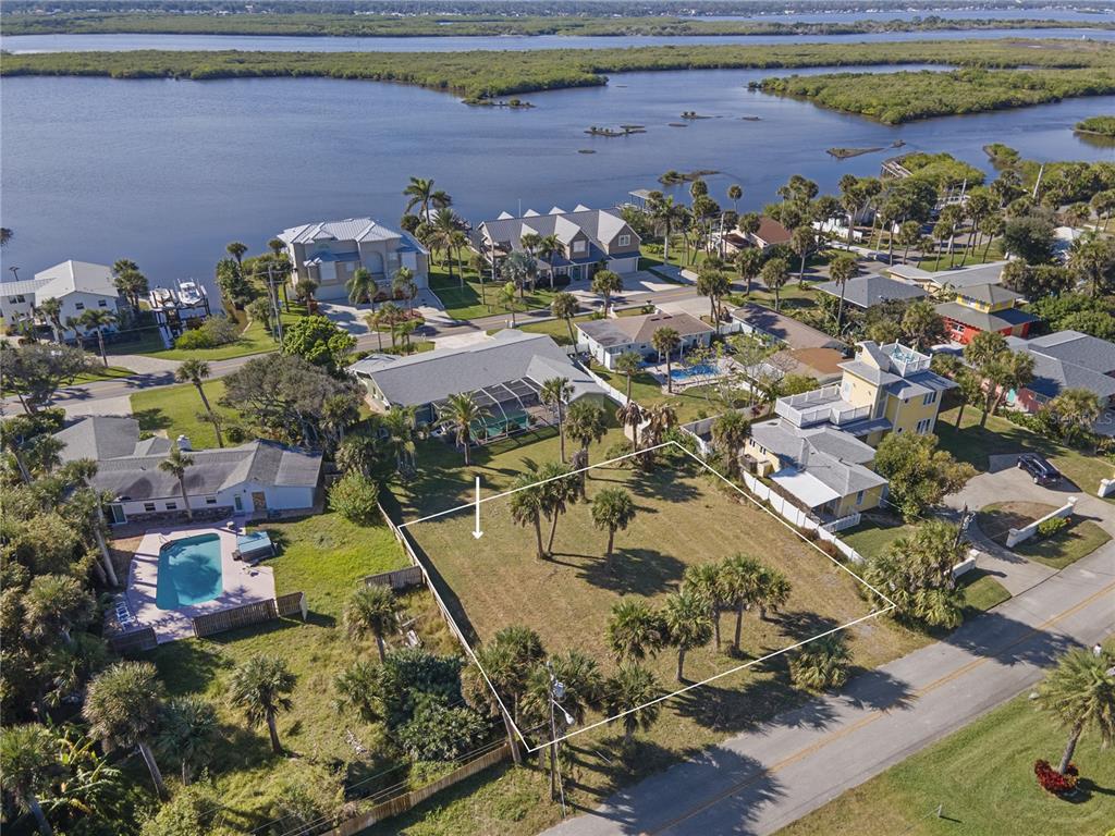 An aerial view shows a vacant, rectangular residential lot surrounded by houses and palm trees — 4216 CARDINAL BOULEVARD, PORT ORANGE, FL
