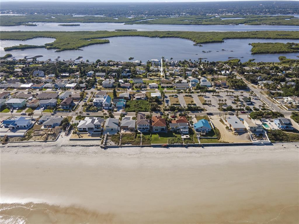 An aerial view shows a coastal neighborhood with a highlighted vacant lot near the beach — 4216 CARDINAL BOULEVARD, PORT ORANGE, FL