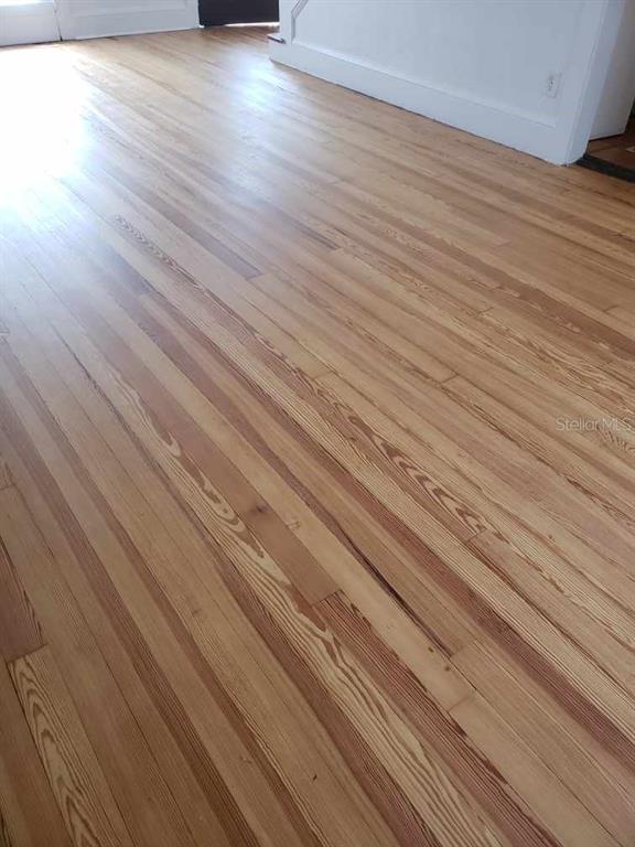A room with light-toned, natural wood flooring and white baseboards — 724 N OLEANDER AVENUE, DAYTONA BEACH, FL